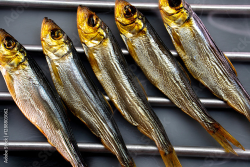 Hot smoked whole herrings on kitchen table. smoked fish isolated on a black background