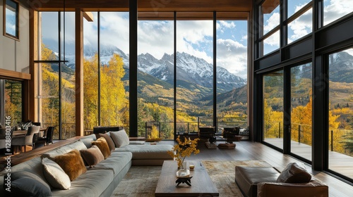 A luxurious modern mountain retreat with floor-to-ceiling windows offering panoramic views of towering snow-capped peaks.
