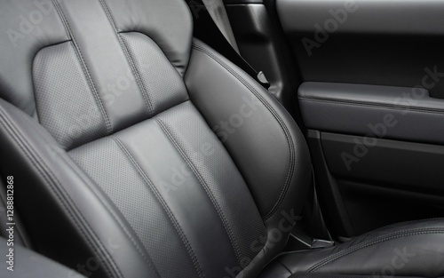 Car black leather interior. Part of black leather car seat details with white stitching. Interior of prestige car. Comfortable perforated leather seats. Perforated leather. photo