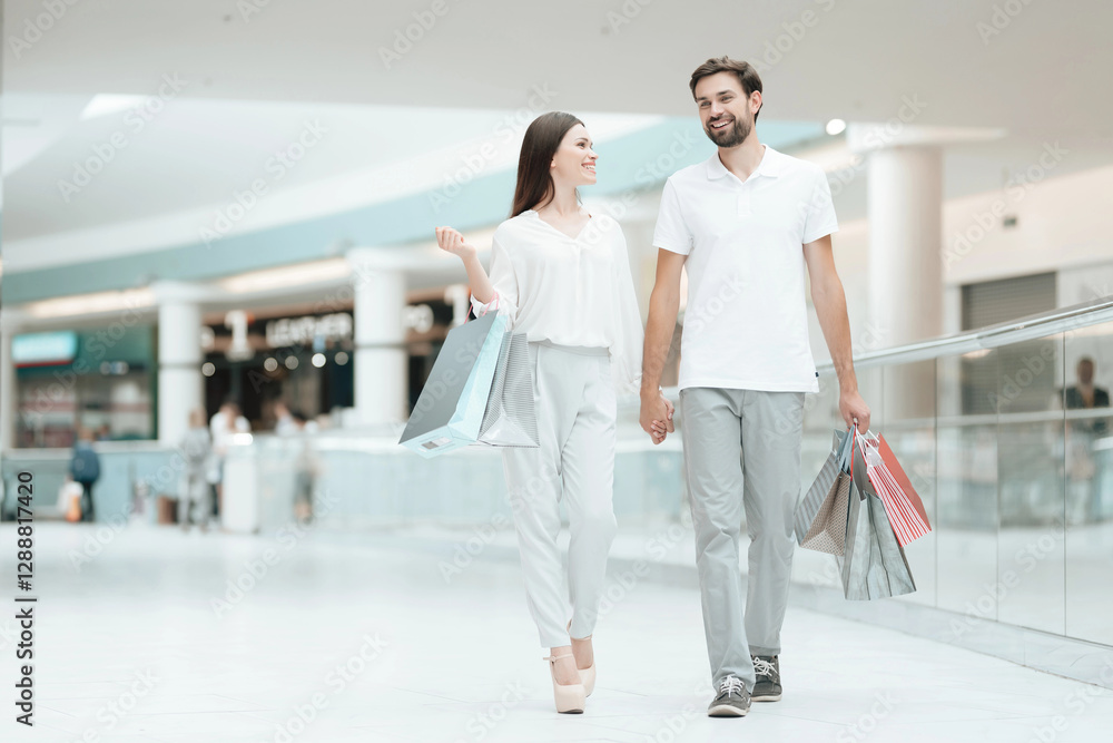 Man and woman are walking from one to another store in shopping mall. Man and woman are walking from one to another store in shopping mall.