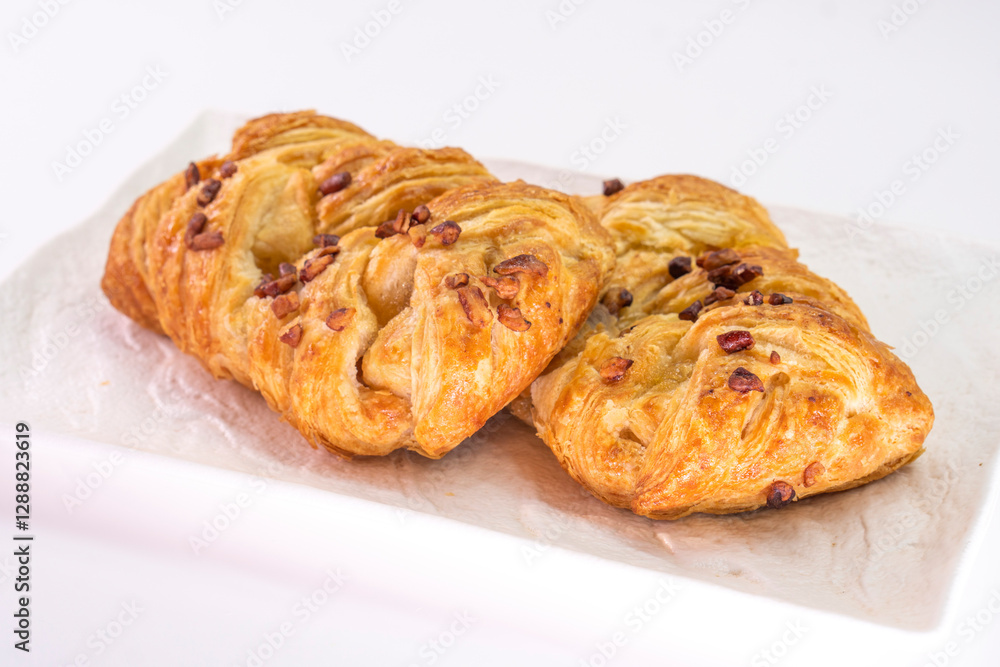 Fresh delicious puff pastry with maple syrup and nuts on white background Fresh delicious puff pastry with maple syrup and nuts on white background