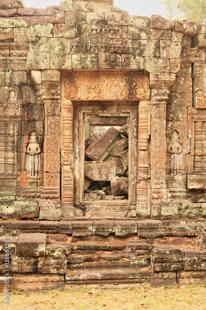 Big rocks, bricks, stones block a door, doorway, gate at the Prasat Preah Khan Temple, flanked by two soldiers, warriors carved into the sandstone, Angkor Wat, Siem Reap, Cambodia Big rocks, bricks, stones block a door, doorway, gate at the Prasat Preah Khan Temple, flanked by two soldiers, warriors carved into the sandstone, Angkor Wat, Siem Reap, Cambodia