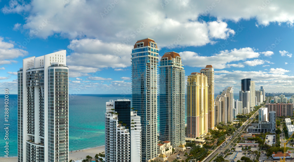 View from above of luxurious highrise hotels and condos on Atlantic ocean shore in Sunny Isles Beach city. American tourism infrastructure in southern Florida