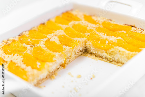 Pie with a sandy crumb with oranges in a forming form