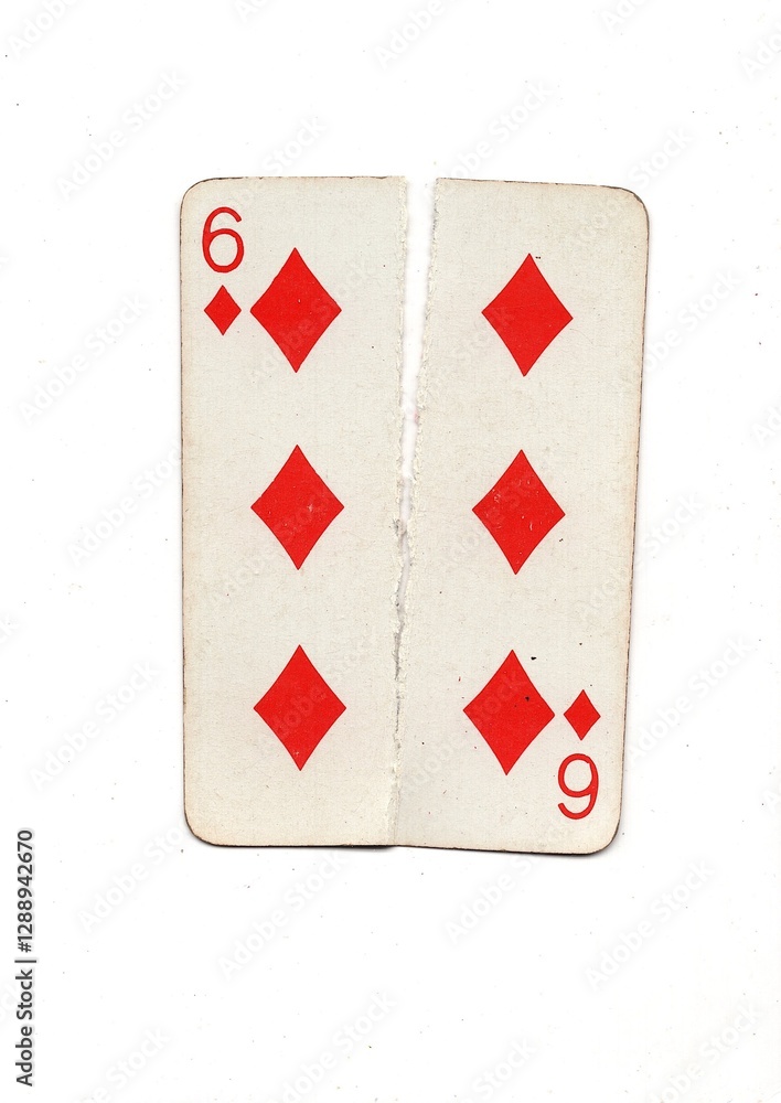 Obraz premium A vintage playing card torn in half from top to bottom on a white background.