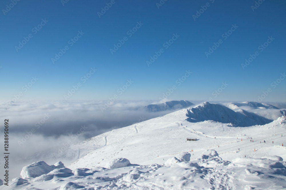 Snowy Mountain Landscape with Ski Slopes Above the Clouds Snowy Mountain Landscape with Ski Slopes Above the Clouds