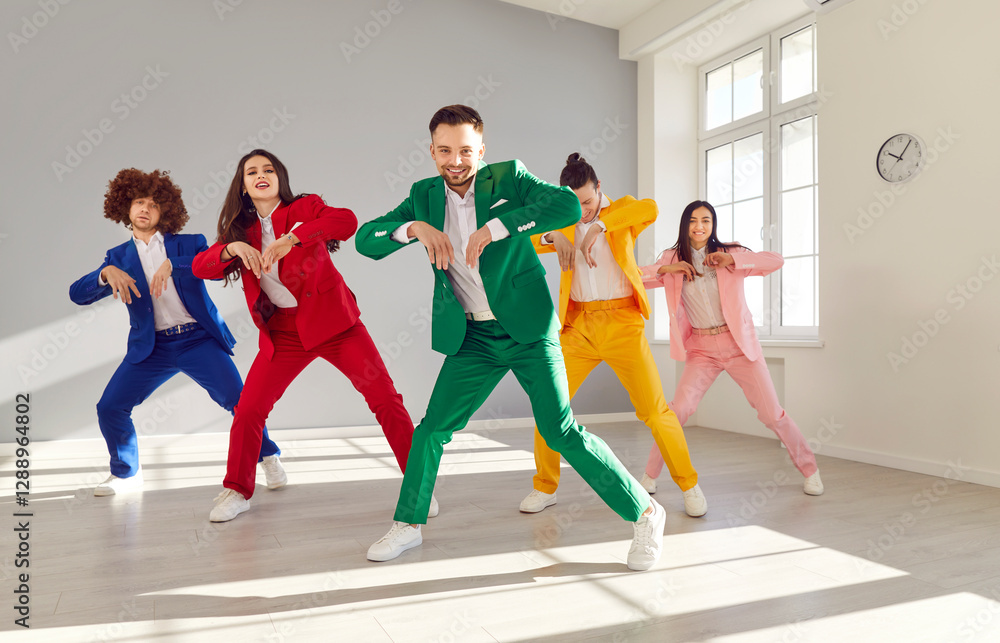 Fototapeta premium Group of energetic dancers rehearsing moves while learning new dance. Young people in bright colorful suits having fun and dancing together indoors. Disco party and active lifestyle concept.