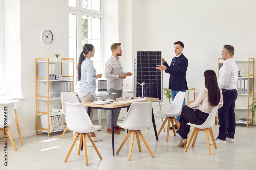 Business coach speaking in front of solar panel, making a presentation of alternative energy sources for a diverse audience in an modern office workplace. Team of employees attending corporate seminar Business coach speaking in front of solar panel, making a presentation of alternative energy sources for a diverse audience in an modern office workplace. Team of employees attending corporate seminar