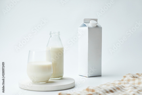 Milk Carton and Glass With Fresh Milk on a Simple White Background in a Bright Kitchen Setting