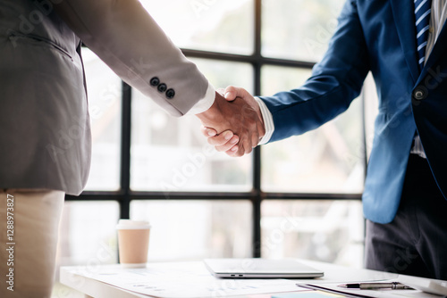 Wallpaper Mural Two men shake hands in a business meeting Torontodigital.ca