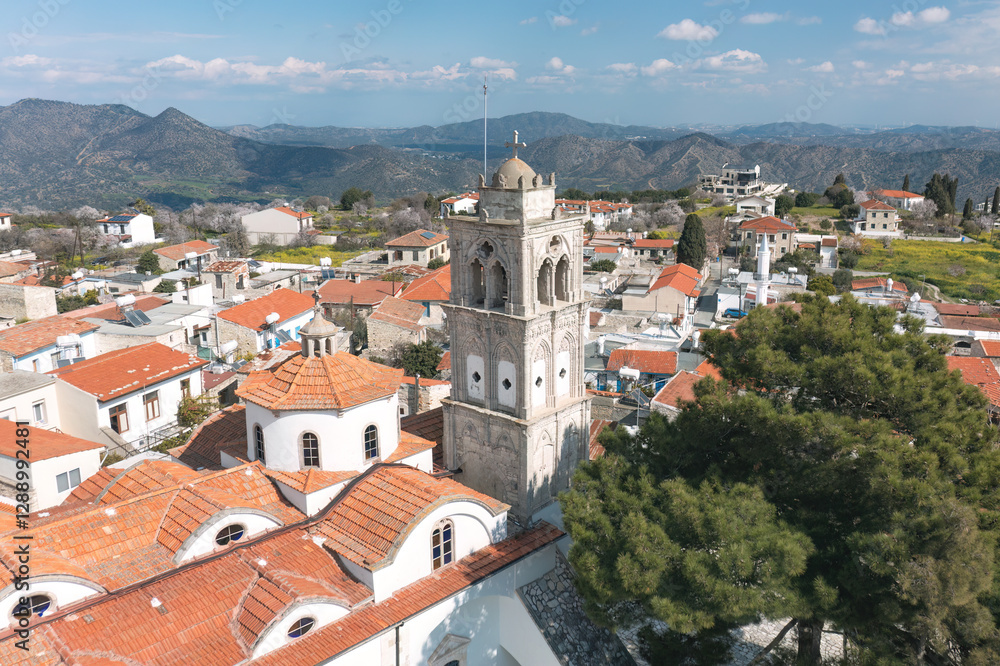 Obraz premium Aerial view of Pano Lefkara village in Cyprus, showcasing traditional architecture, red-tiled roofs, and surrounding mountainous landscape. Larnaca District