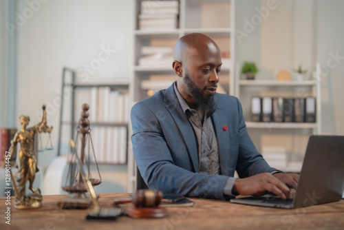 Photography Lawyer working diligently on a laptop in an office, surrounded by justice figure