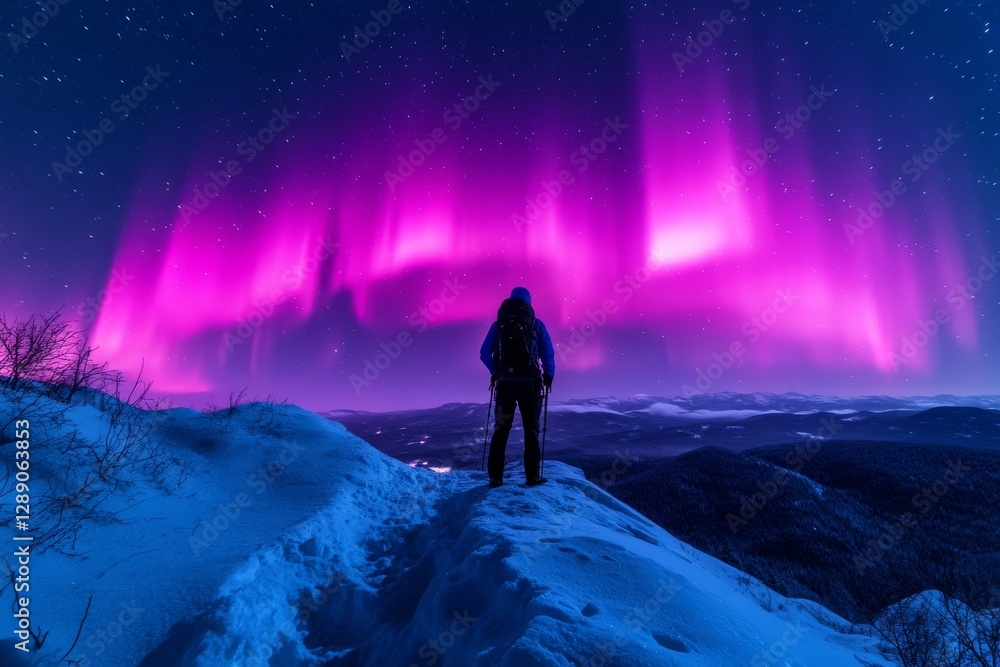 Fototapeta premium Silhouetted hiker beneath violet aurora waves