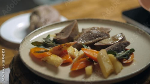 A close-up of a finished dish. This is veal with root vegetables and sage