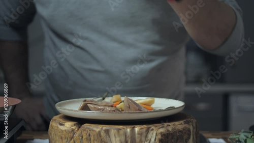 Final touch in serving the dish. Cooking process. Dish with meat and vegetables