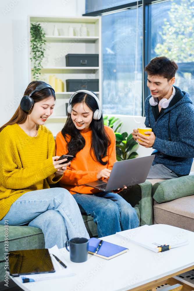 Three Asian young adult students sit in university living room, discussing their study abroad experiences, academic research, preparing thesis report, planning future global education opportunities. Three Asian young adult students sit in university living room, discussing their study abroad experiences, academic research, preparing thesis report, planning future global education opportunities.