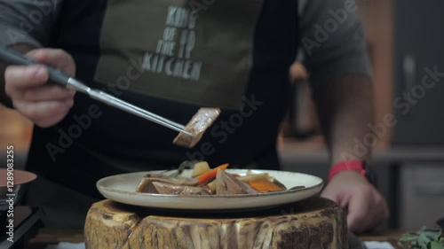 Final touch in serving the dish. Cooking process. Dish with meat and vegetables