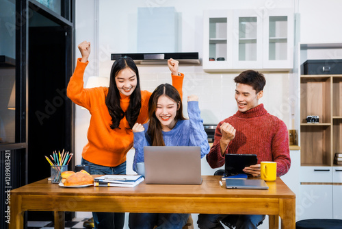 Wallpaper Mural Three Asian young adult students sit around the kitchen table, attending online class on tablet. They engage in video conferencing, discussing lessons, taking notes, digital learning experience. Torontodigital.ca