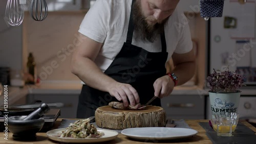 Chef close-up preparing beef with root vegetables. cooking process