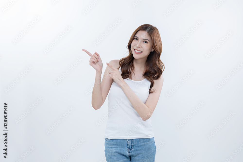 Isolated asian woman smiling and pointing to blank copy space Isolated asian woman smiling and pointing to blank copy space