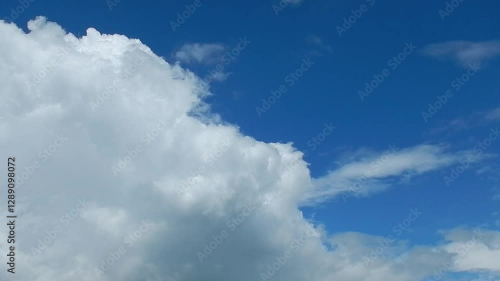 Blue sky and slowly moving dangerous rainy and stormy clouds during weather change and approaching storm - natural sky background. Topics: cloudscape, sky space, weather, meteorology, season Blue sky and slowly moving dangerous rainy and stormy clouds during weather change and approaching storm - natural sky background. Topics: cloudscape, sky space, weather, meteorology, season
