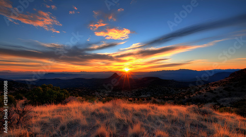 Vibrant Sunset Over Distant Mountains and Desert Landscape