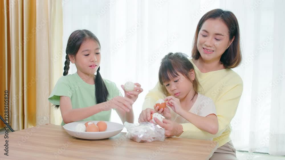Happy family, father, mother and daughter are having fun playing hair styling game for daughter in living room Happy family, father, mother and daughter are having fun playing hair styling game for daughter in living room