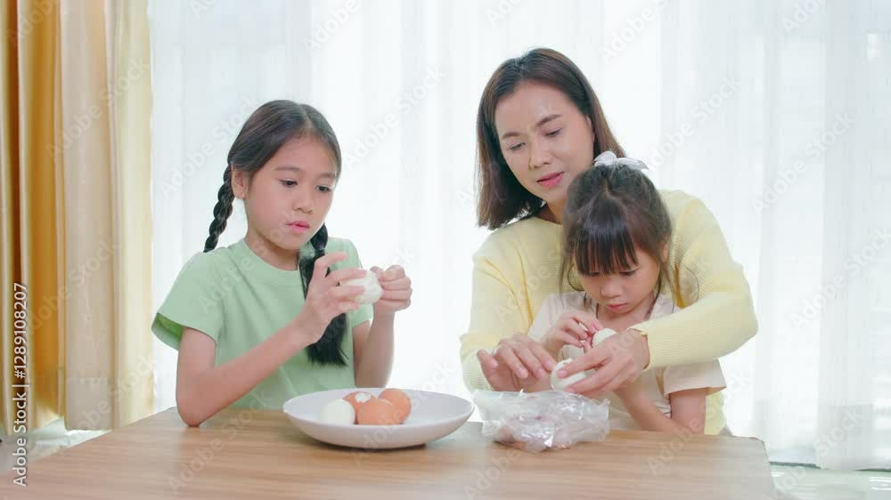 Happy family, father, mother and daughter are having fun playing hair styling game for daughter in living room Happy family, father, mother and daughter are having fun playing hair styling game for daughter in living room