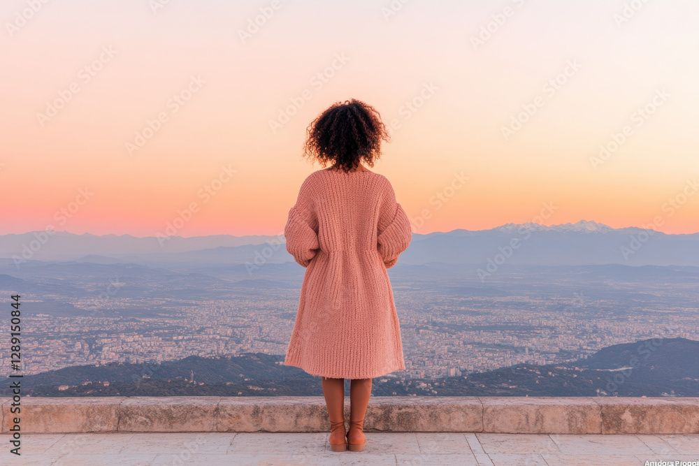A woman stands on a ledge overlooking a city A woman stands on a ledge overlooking a city