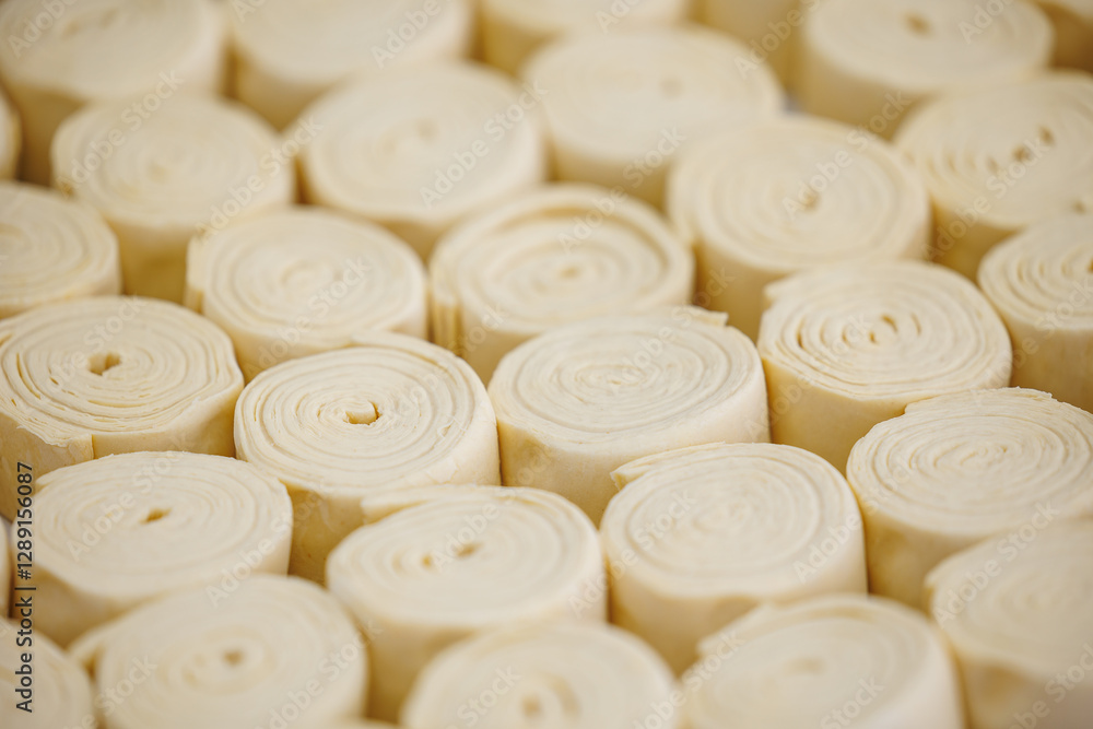 Rolled dough for pastries prepared in industrial bakery factory setting, top view Rolled dough for pastries prepared in industrial bakery factory setting, top view