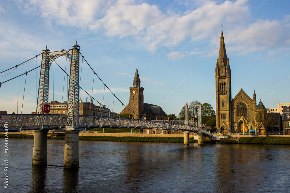 Naklejka premium A wrought iron suspension bridge, which acts as a pedestrian crossing over the River Ness in Inverness, Scotland.
