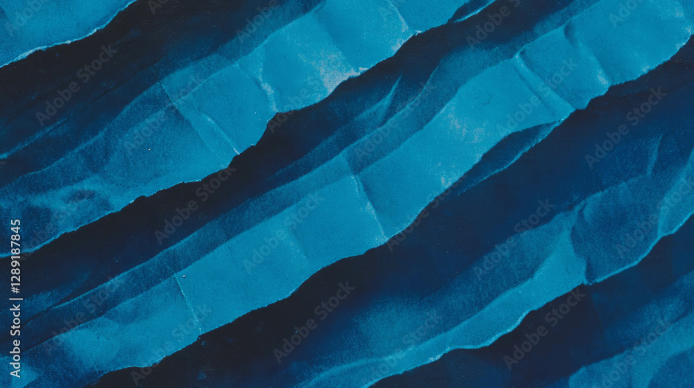 Obraz premium Dramatic deep wavy ribbed blue paper texture for artistic design and background use