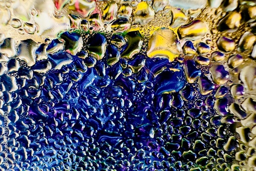 Close-up of water drops on metal surface in high resolution showing condensation of water droplets on metal surface. Intricate patterns and different sized water droplets create a beautiful abstract