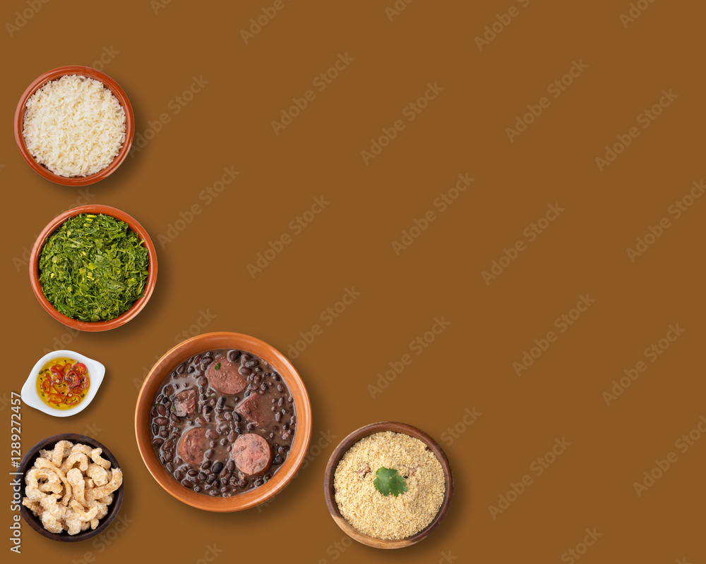 Traditional brazilian feijoada with rice, kale, manioc flour, cracklings and copy space over brown background Traditional brazilian feijoada with rice, kale, manioc flour, cracklings and copy space over brown background