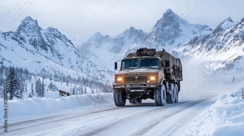 A military truck is traversing a snowy mountain terrain