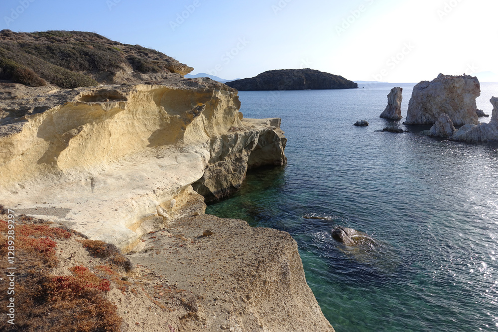 Fototapeta premium Paradise sandy organised beach of Mavrospilia with white rock formations best place to see the sunset in the island of Kimolos, Cyclades, Greece