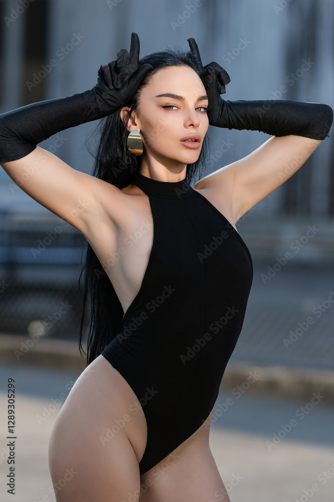 Fototapeta premium Fashion Brunette model evil girl shows fingers horns. Sexy glamour devil woman doing gesture with finger over head as bull horns. Falling angel. Portrait of bad angel or devil girls.