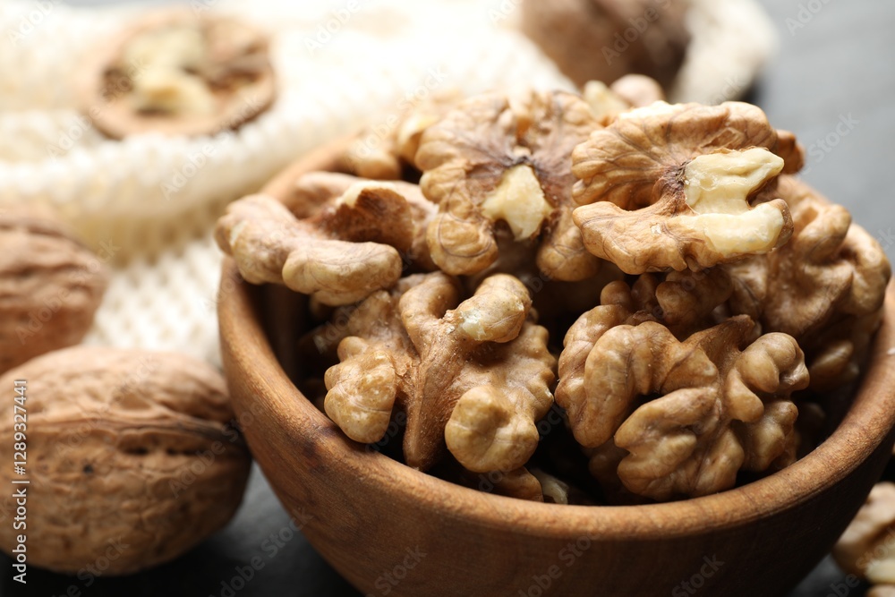 Fresh ripe walnuts in bowl on table, closeup Fresh ripe walnuts in bowl on table, closeup
