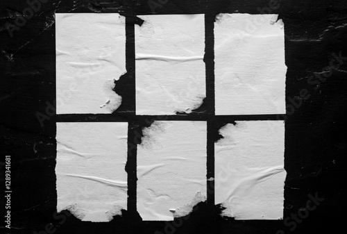 Set of white torn posters on black background.