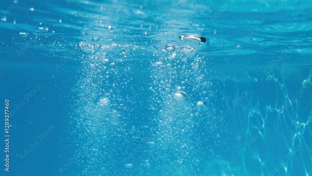Naklejka premium Underwater scene showcasing bubbles in clear blue water.
