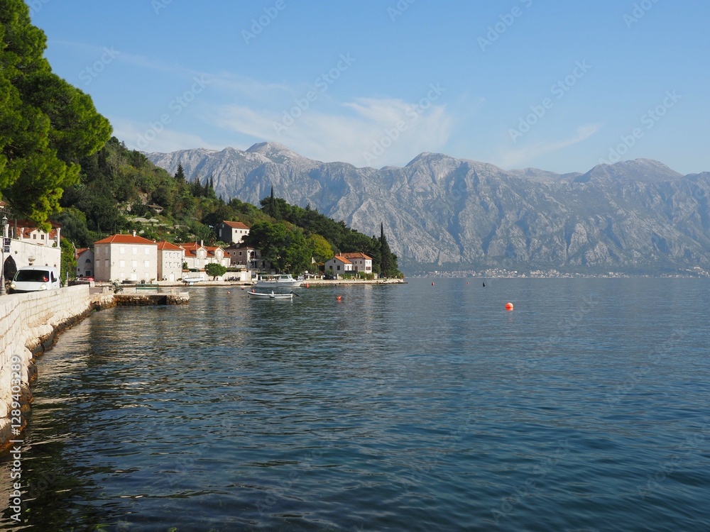 Beautiful panoramic view of the Bay of Kotor and embankment of Perast, Montenegro. Calm water and mountains on a sunny day Beautiful panoramic view of the Bay of Kotor and embankment of Perast, Montenegro. Calm water and mountains on a sunny day