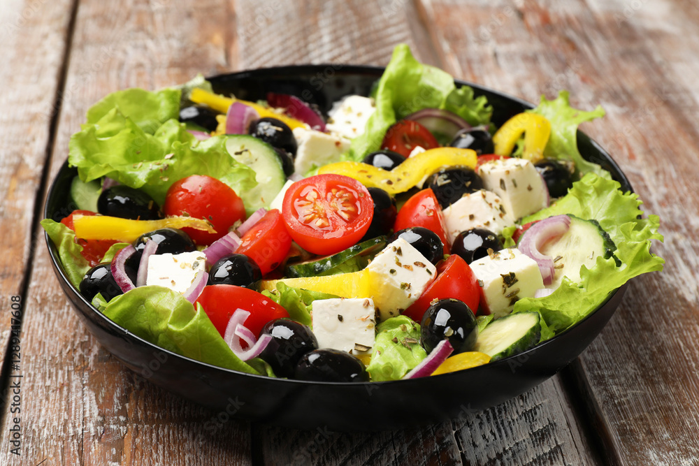 Delicious fresh Greek salad on wooden table, closeup Delicious fresh Greek salad on wooden table, closeup