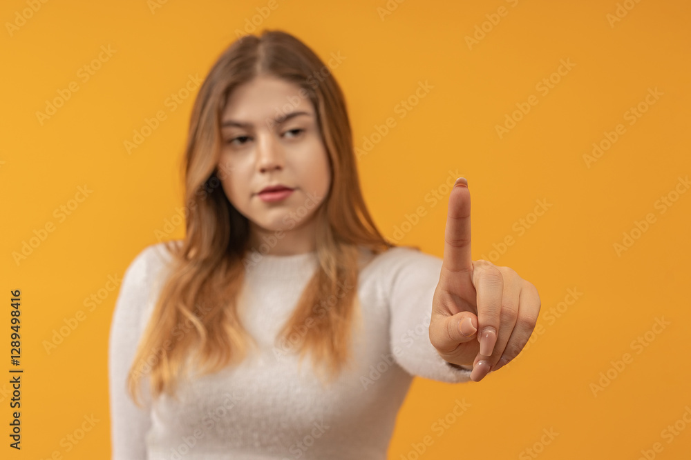 Young woman pointing forward with focus and determination Young woman pointing forward with focus and determination