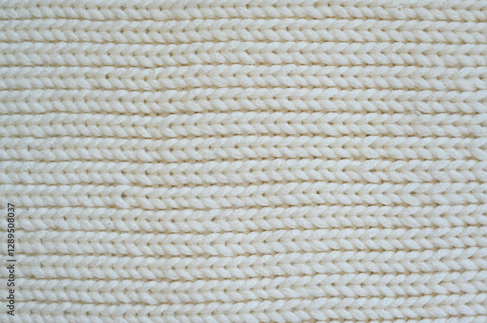 white texture of knitted wool fabric as a background, white smooth symmetrical lines of hand-knitted needlework pattern
white texture of knitted wool fabric as a background, white smooth symmetrical lines of hand-knitted needlework pattern