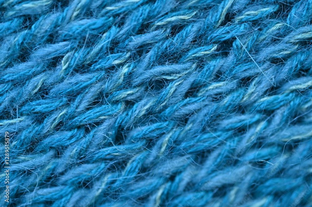 Fototapeta premium blue texture of knitted wool fabric as a background, smooth symmetrical lines of hand-knitted needlework pattern 