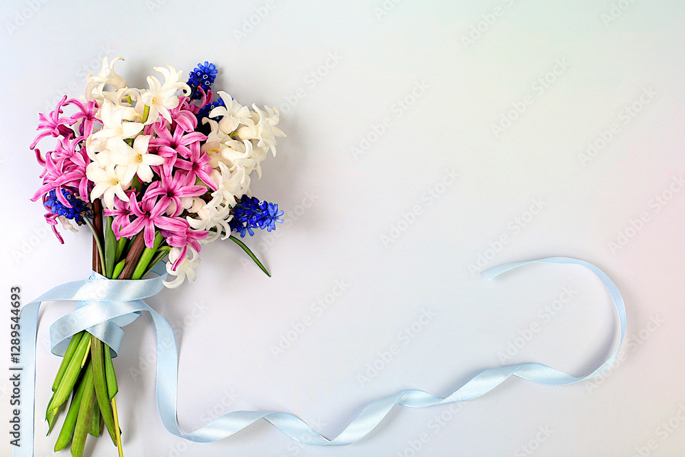 Obraz premium Bouquet with beautiful spring flowers hyacinths and muscari in vase on light background, banner,Abstract floral arrangement, still life with space for text, floral holiday card, 