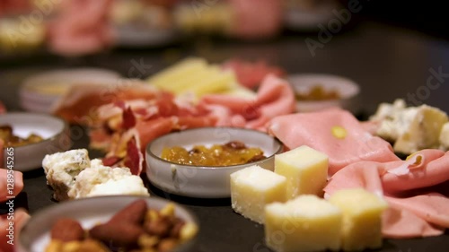 Cheese, meat, grapes and olives antipasto. Appetizer selection on plate. Top view with copy space. Flat lay. High quality photo
