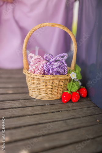 Decorative knit basket with yarn and miniature strawberries