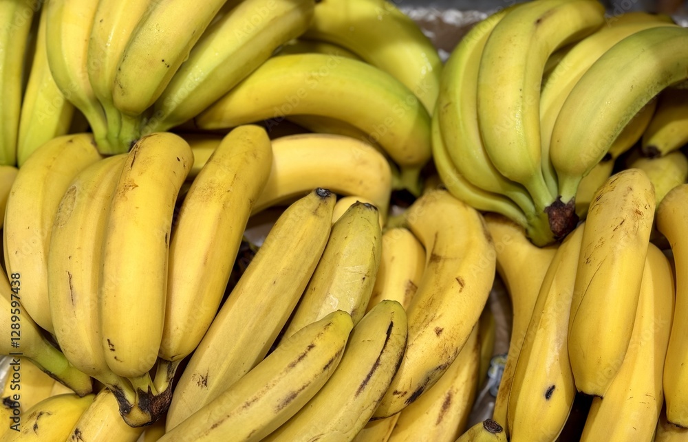 Ripe juicy yellow bananas close-up on a shelf in a supermarket. Close-up. Ripe juicy yellow bananas close-up on a shelf in a supermarket. Close-up.