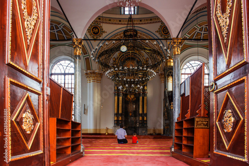 Praying father and son. Konya Aziziye Mosque. photo